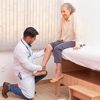 doctor checking woman's knee